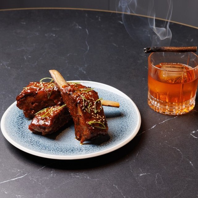 Smoky Lamb Ribs and and a smoky cocktail make for …